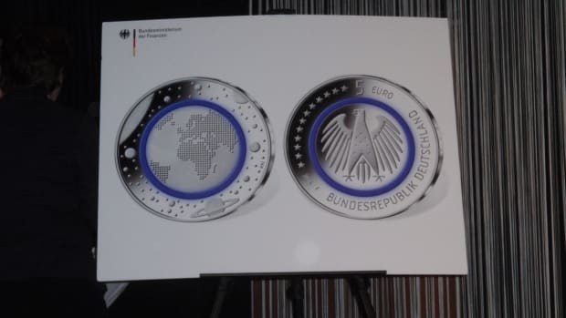 A closer view of the new German Planet Earth 5-euro coin with the polymer ring colored blue.