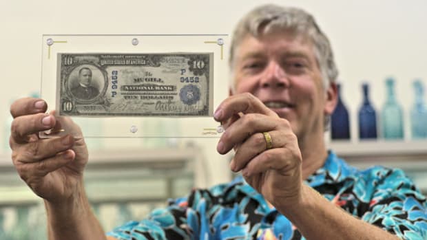 Fred Holabird holds a rare McGill National Bank note.