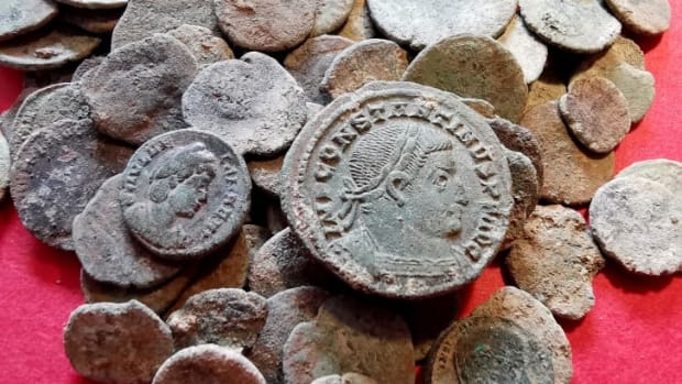 Some of the ancient Roman coins a badger helped find in a Spanish cave. The coins were minted between 200 and 400 C.E. in different parts of the Roman Empire.