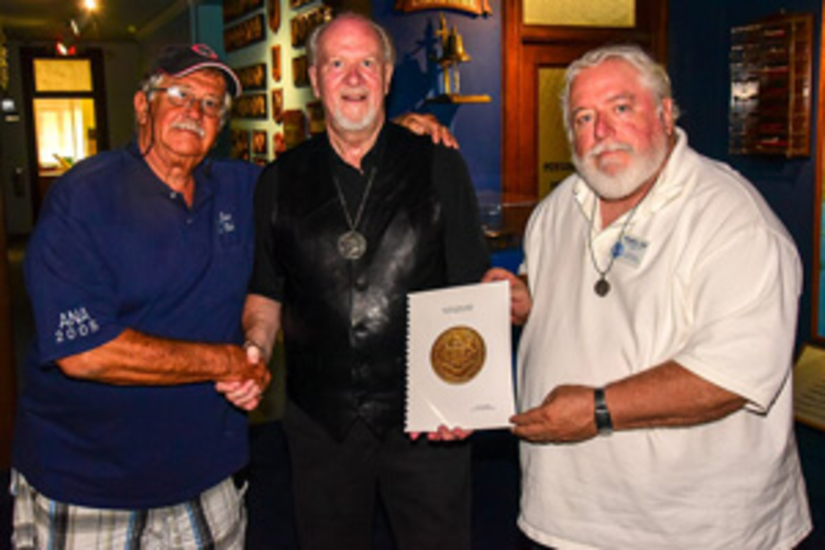  A unique hand copy of his presentation is given by Scott E. Douglas, center, to Don Hill right, CSNA’s librarian. Michael S. Turrini is at left.