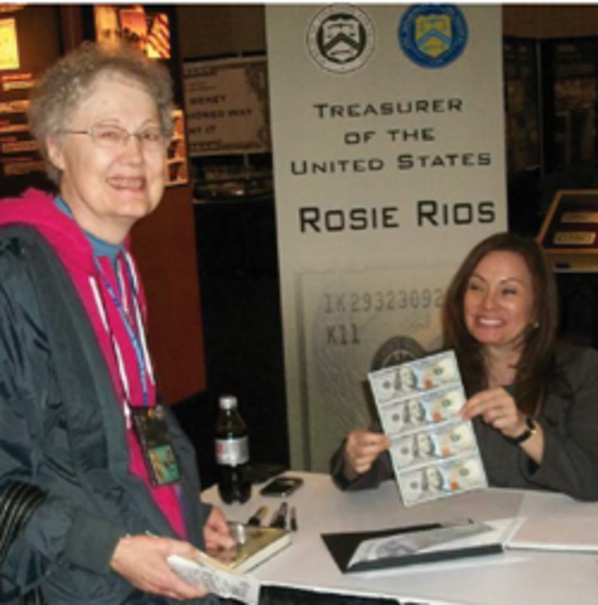 Nancy Wilson with U.S. Treasurer Rosa “Rosie” Gumataotao Rios. Rios is holding the $100 sheet she signed as No. 1 for Wilson.