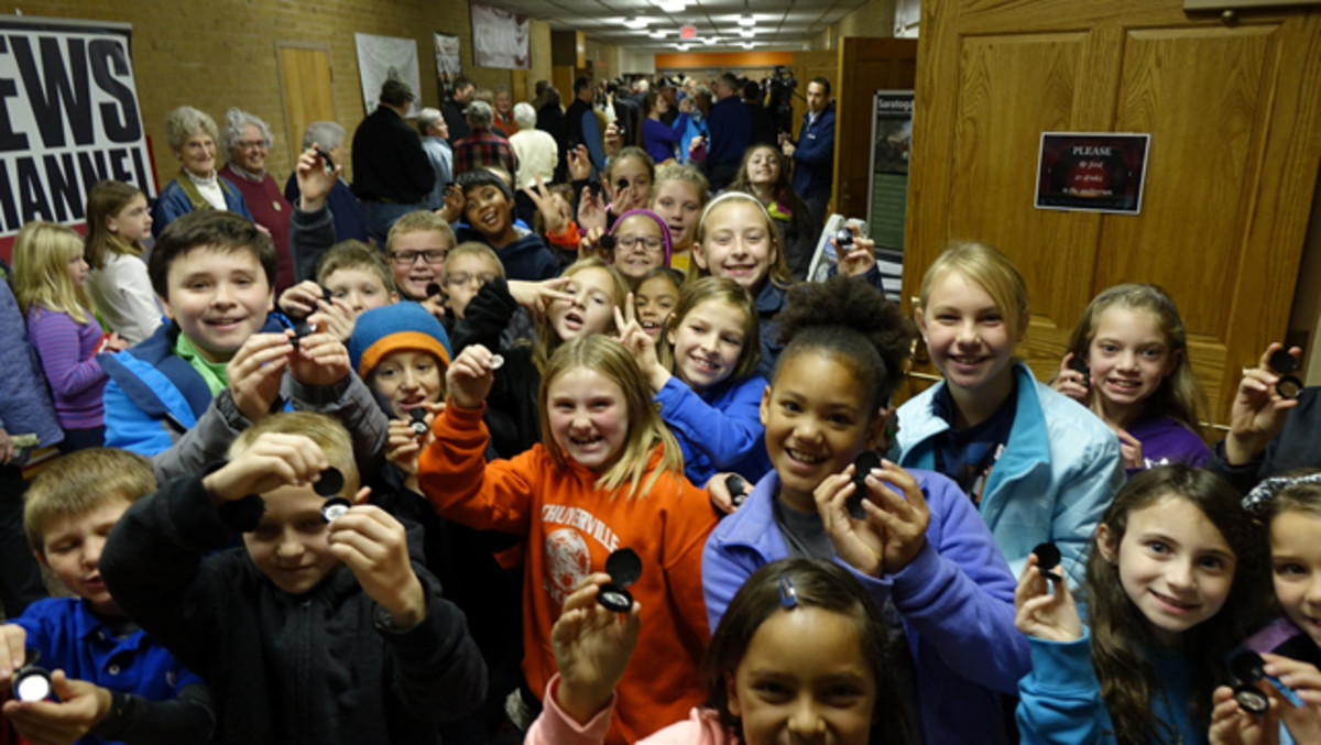 Who says kids can't have fun with coins? Fourth grade students show off their new Saratoga National Historical Park quarters after the launch ceremony in Schuylerville, NY, on Nov. 17, 2015. The coin is the 30th release in the United States Mint America the Beautiful Quarters® Program. U.S. Mint photo by Sharon McPike.