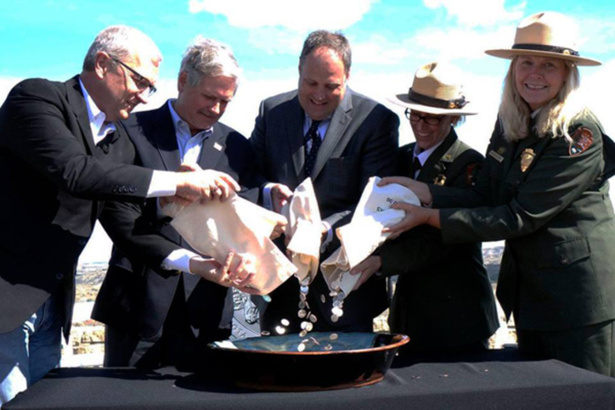 From left, Rep. Kevin Cramer, Sen. John Hoeven, Rhett Jeppson, park superintendent Wendy Ross and National Park Service Deputy Director Patricia Trap join in the ceremonial coin pour. (Debbie Dawson Mint photo.)