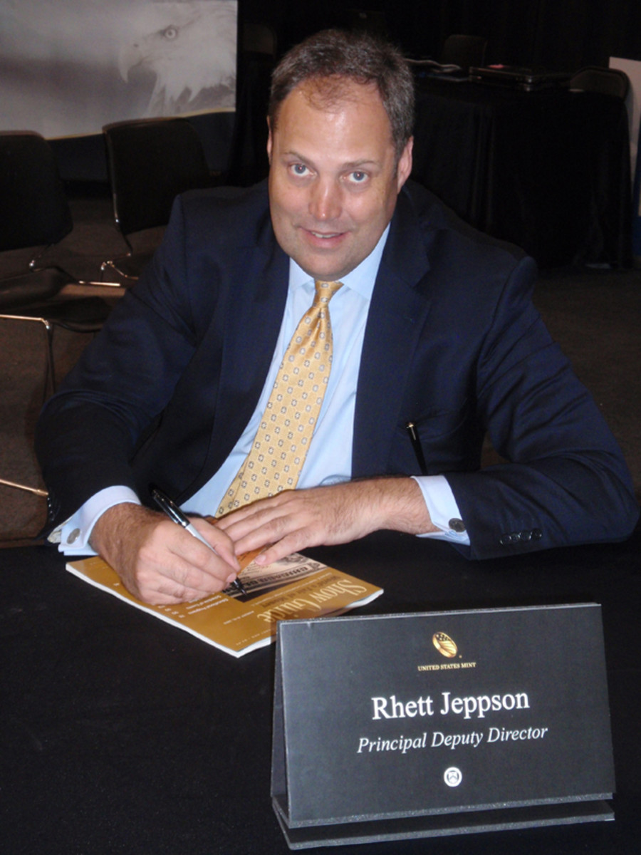 Rhett Jeppson, pictured here signing autographs at the Chicago ANA show, is the Principal Deputy Director of the United States Mint