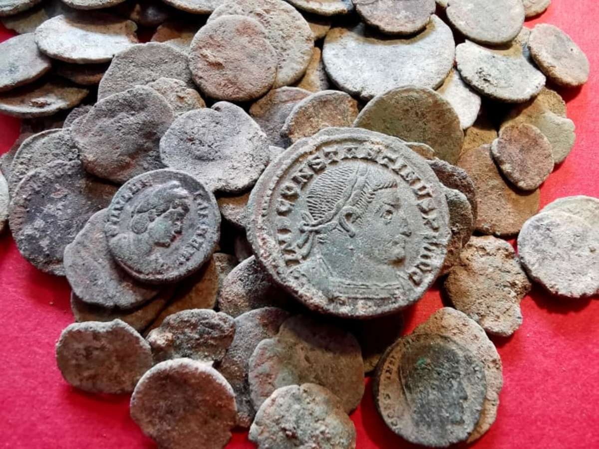 Some of the ancient Roman coins a badger helped find in a Spanish cave. The coins were minted between 200 and 400 C.E. in different parts of the Roman Empire.