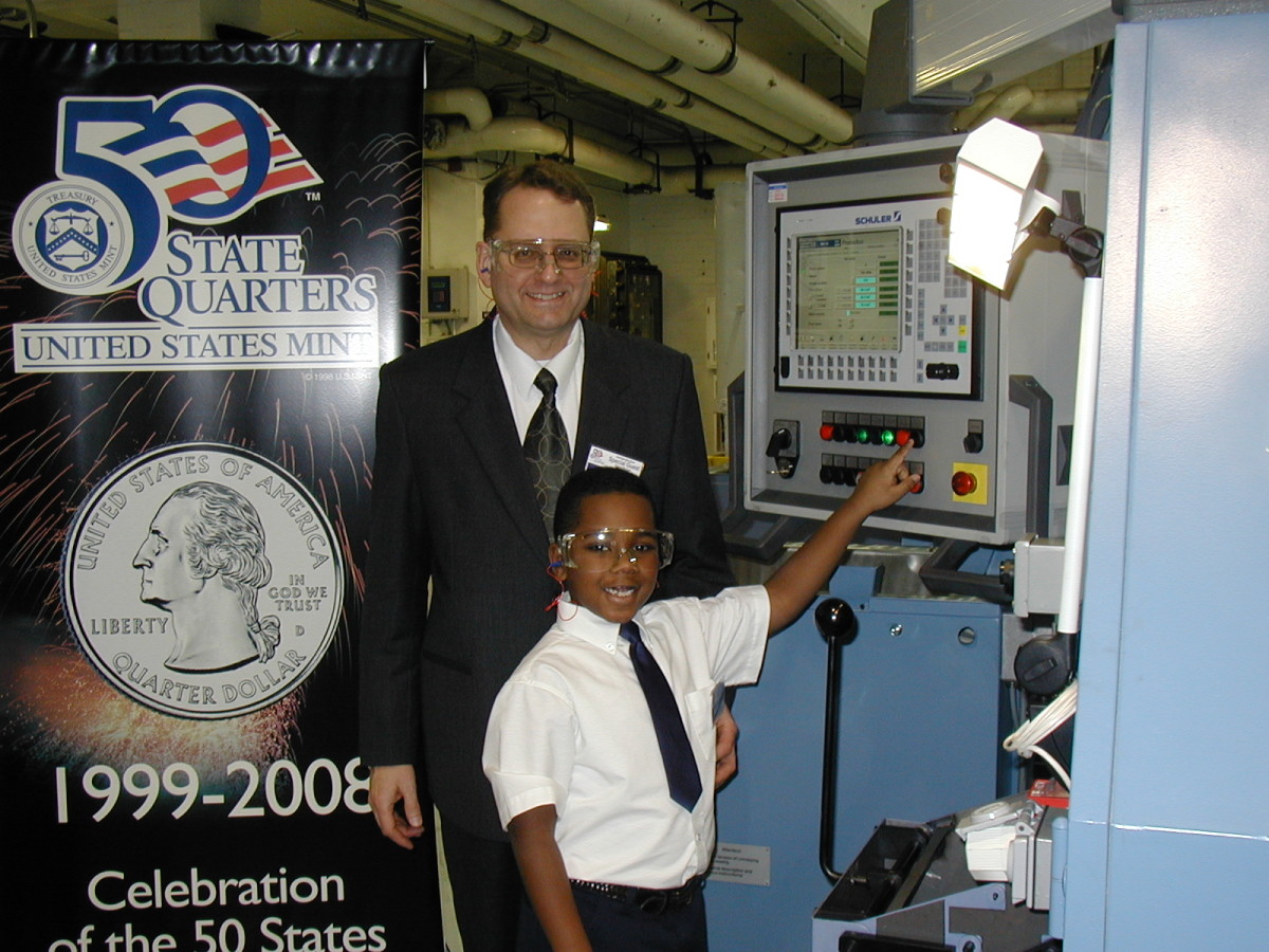 Patrick Heller and his son, Daniel, participate in the January 2004 Ceremonial Strike Ceremony for the Michigan state quarter, held at the Denver Mint facility. At 6 years old, Daniel may have been the youngest person to strike a United States coin. (Image courtesy Patrick A. Heller.)