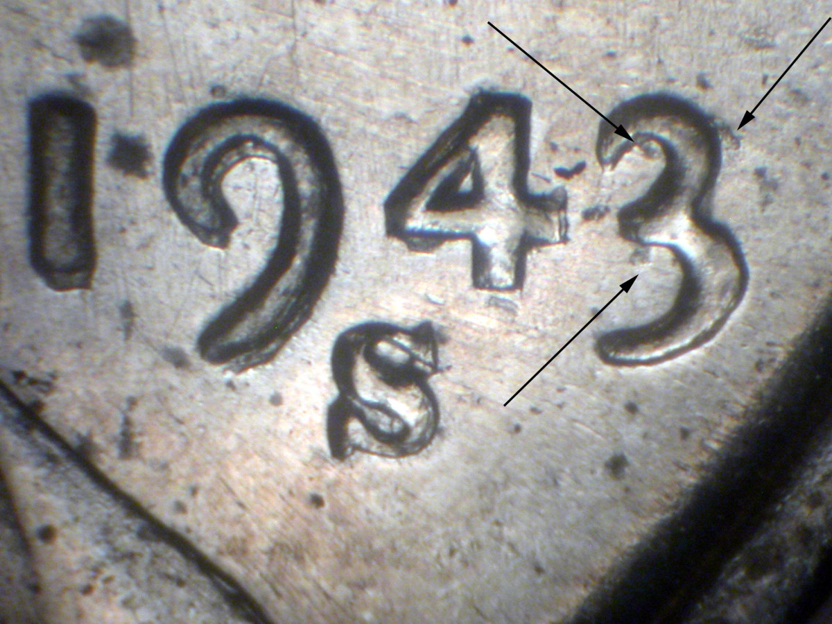 The 1943/1942-S Lincoln cent, FS-101, with arrows highlighting the remains of the 2. (Image courtesy Dr. James Wiles. Used with permission.)