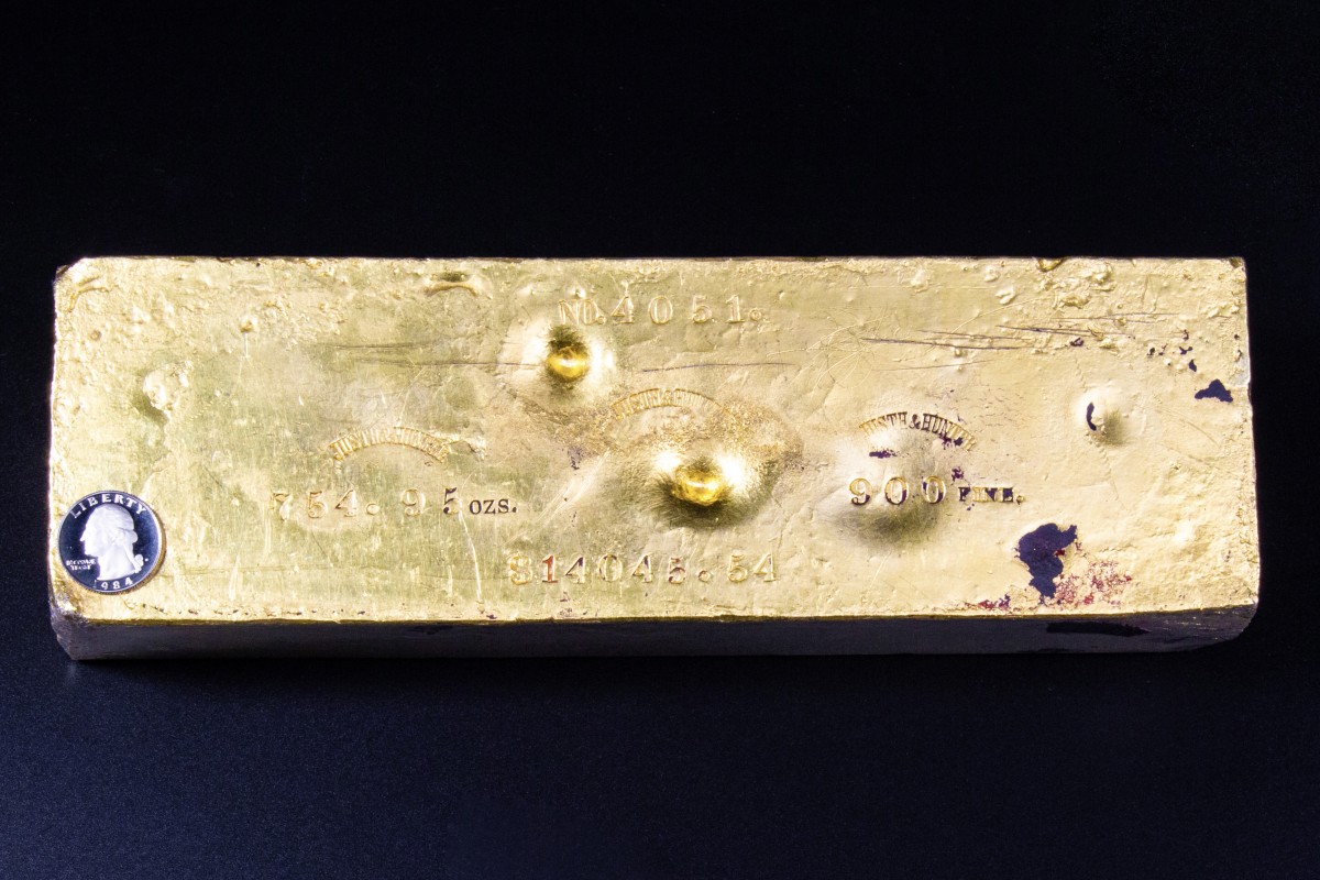 With a quarter on it for size comparison, this Justh & Hunter gold ingot recovered from the S.S. Central America has been sold for more than $2 million.