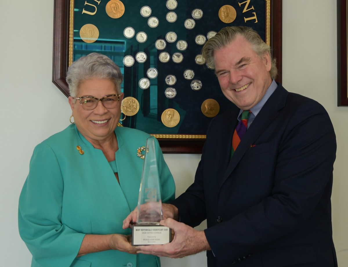 United States Mint Director Ventris C. Gibson accepts a trophy for Most Historically Significant Coin for its 2020 Women's Suffrage Centennial silver dollar. Peter H. Miller, Home Group president for Active Interest Media, home of the COTY awards, presents the award Nov. 10.